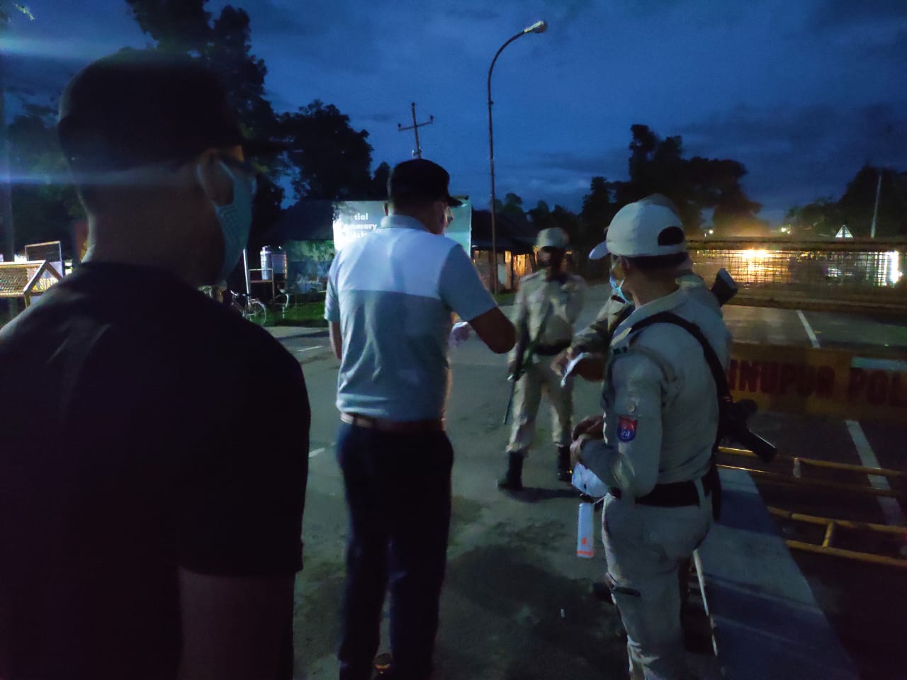 Interacting with Police personells and distributing masks manufactured by the departments of Zoology and Botany, MU at Moirang Bazar in the evening of Monday, the 15th June,2020.